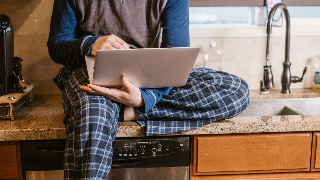 pessoa usando notebook em bancada de cozinha